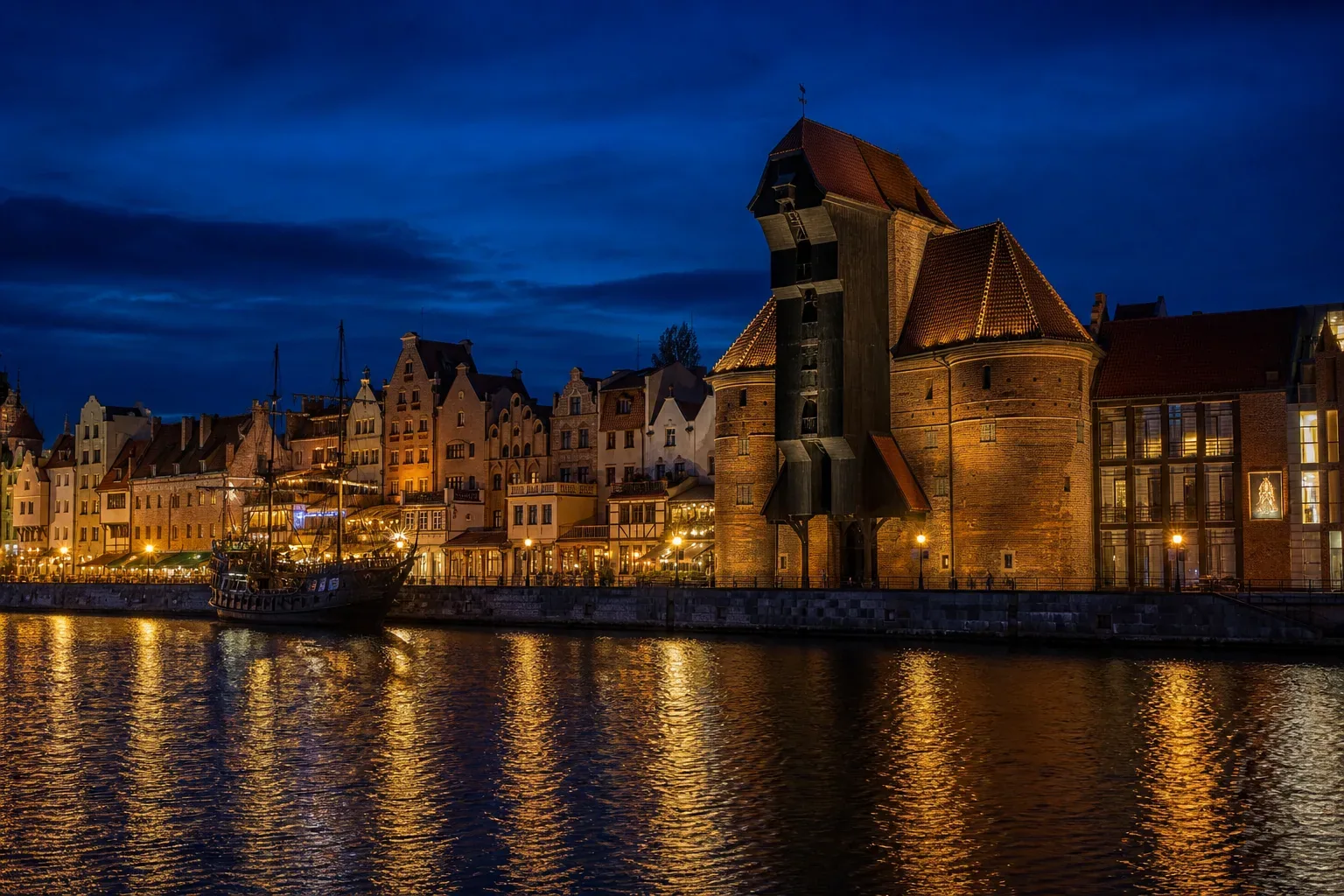 The medieval Gdańsk Crane and gabled merchant houses on the Motława waterfront at dusk
