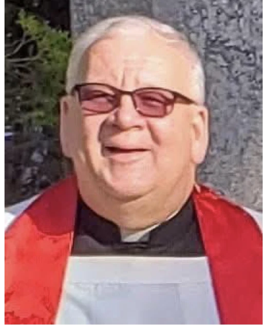 Fr. Ed Namiotka in a red stole and white surplice